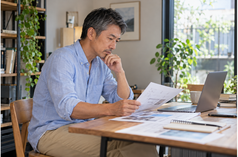 仕事の資料を確認する私服の男性
